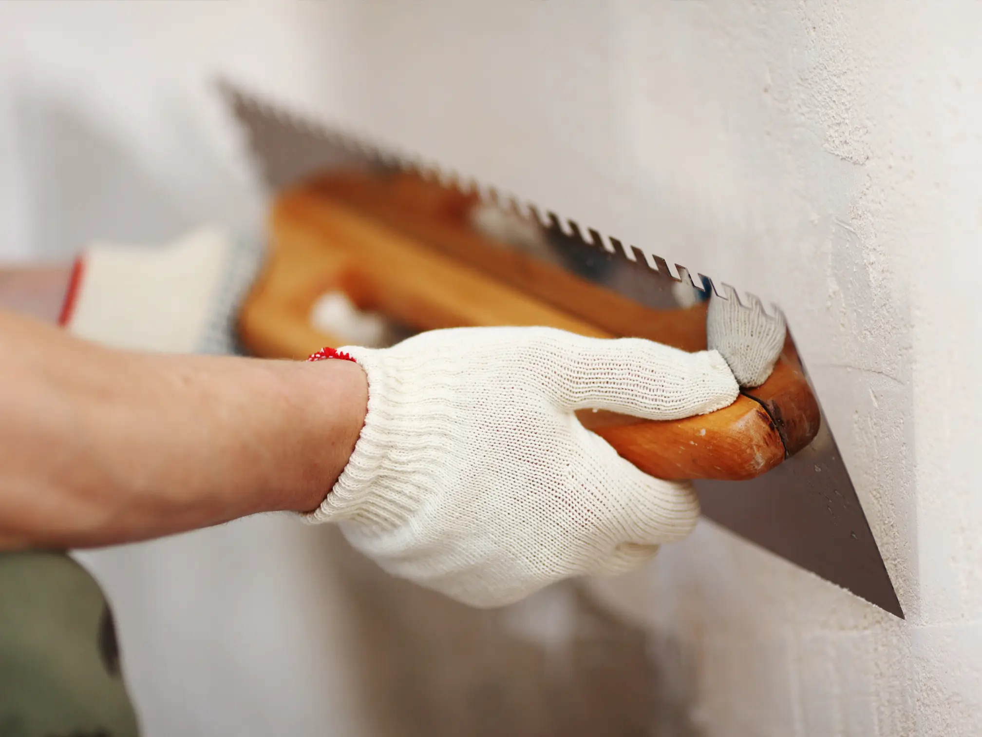 Stucco repair being applied by hand